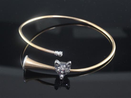 An Edwardian novelty gold, silver and rose cut diamond set bangle modelled as a hunting horn with fox head motif,